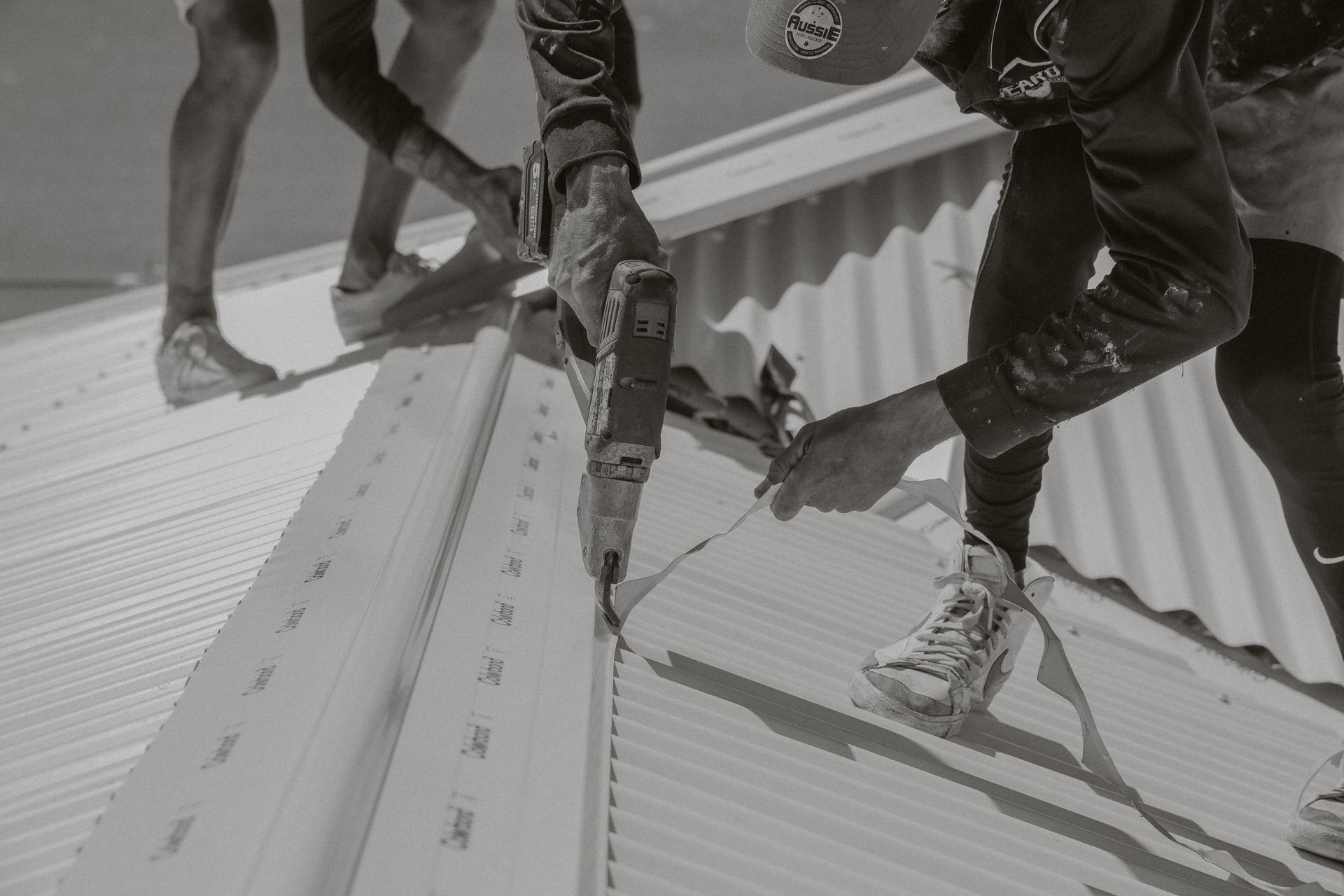 A Roofer Installing Colorbond Roofing— Beards Roofing and Plumbing in Redcliffe, QLD