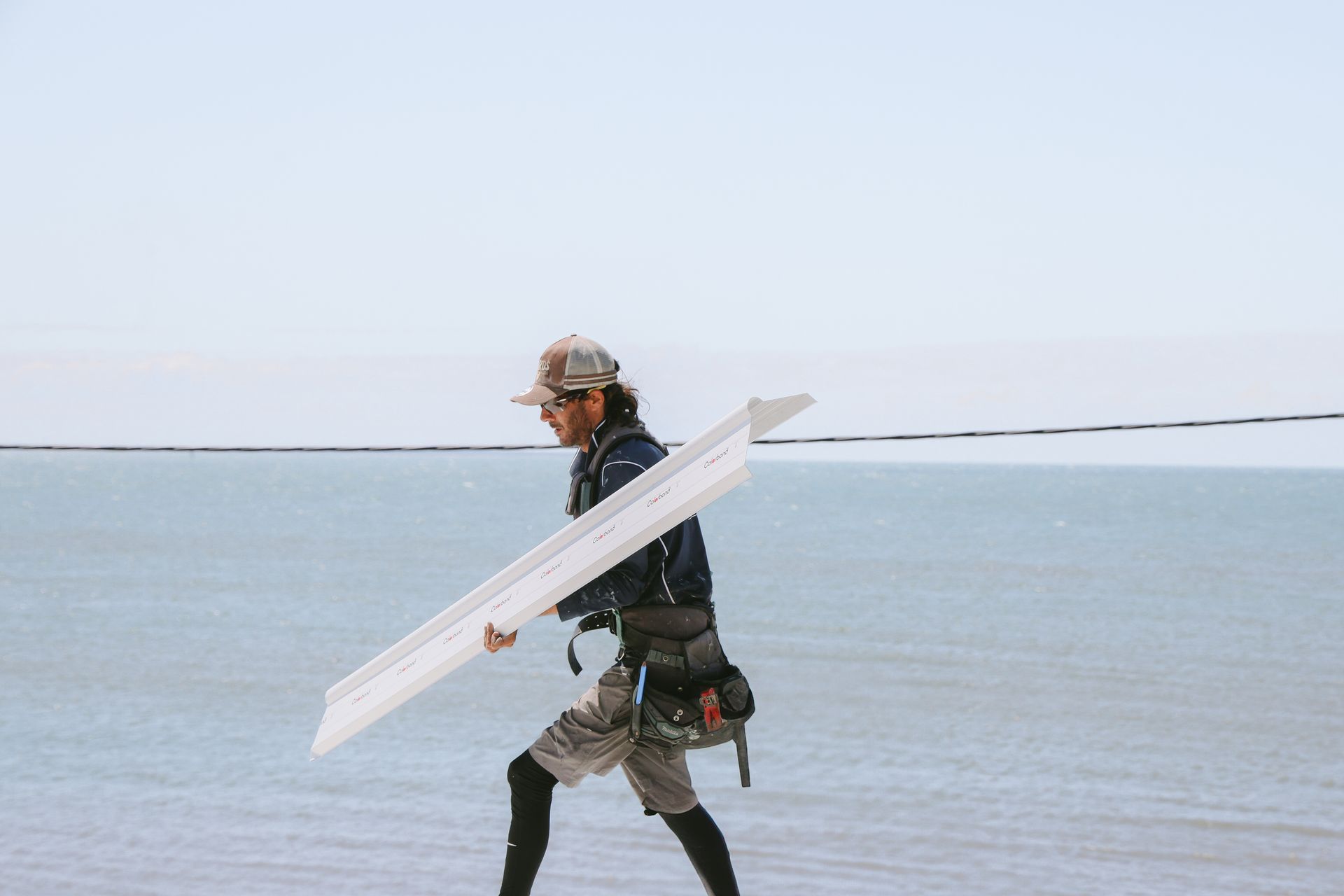 A Roofer Carrying Colorbond Roofing Materials — Beards Roofing and Plumbing in Redcliffe, QLD