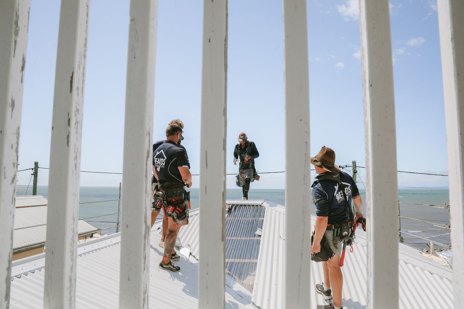 Four Men Completing A Roofing Job — Beards Roofing and Plumbing in North Lakes, QLD