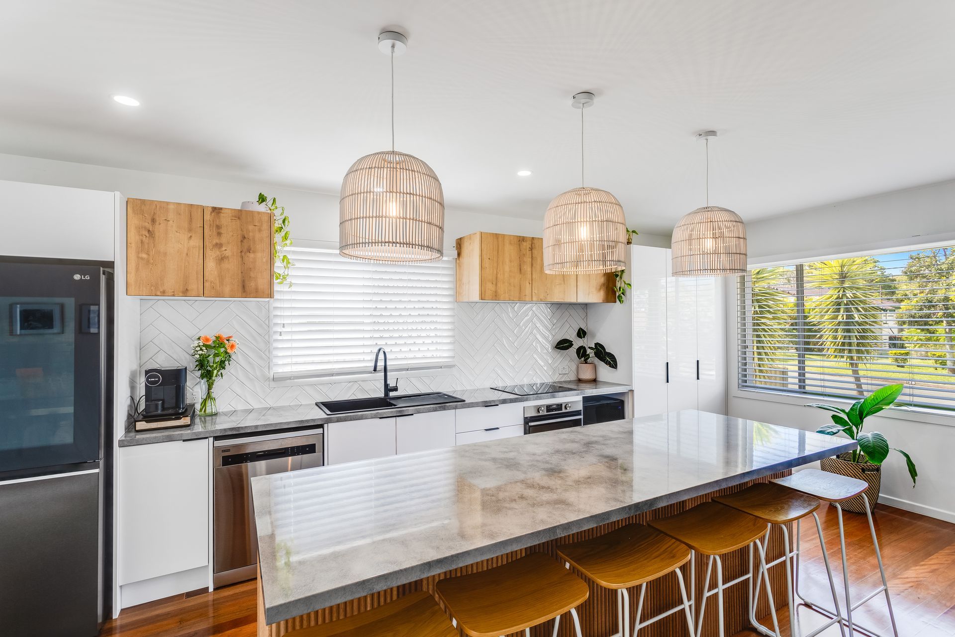 Kitchen With White Cabinets, Stainless Steel Appliances, and a Large Island — Beards Roofing and Plumbing in Clontarf, QLD