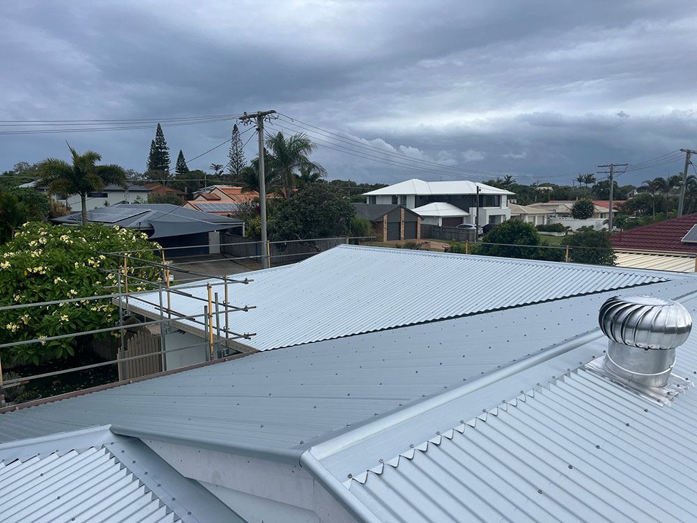 A White Roof With a Wind Turbine on Top of It — Beards Roofing and Plumbing in Caboolture, QLD