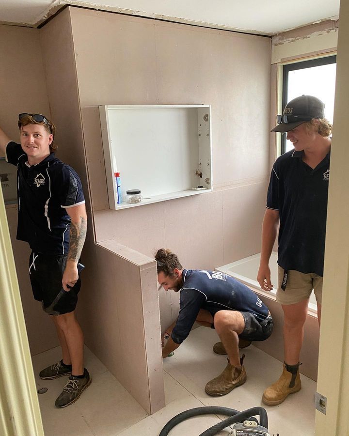 A Group of Men Are Working in a Bathroom — Beards Roofing and Plumbing in Morayfield, QLD