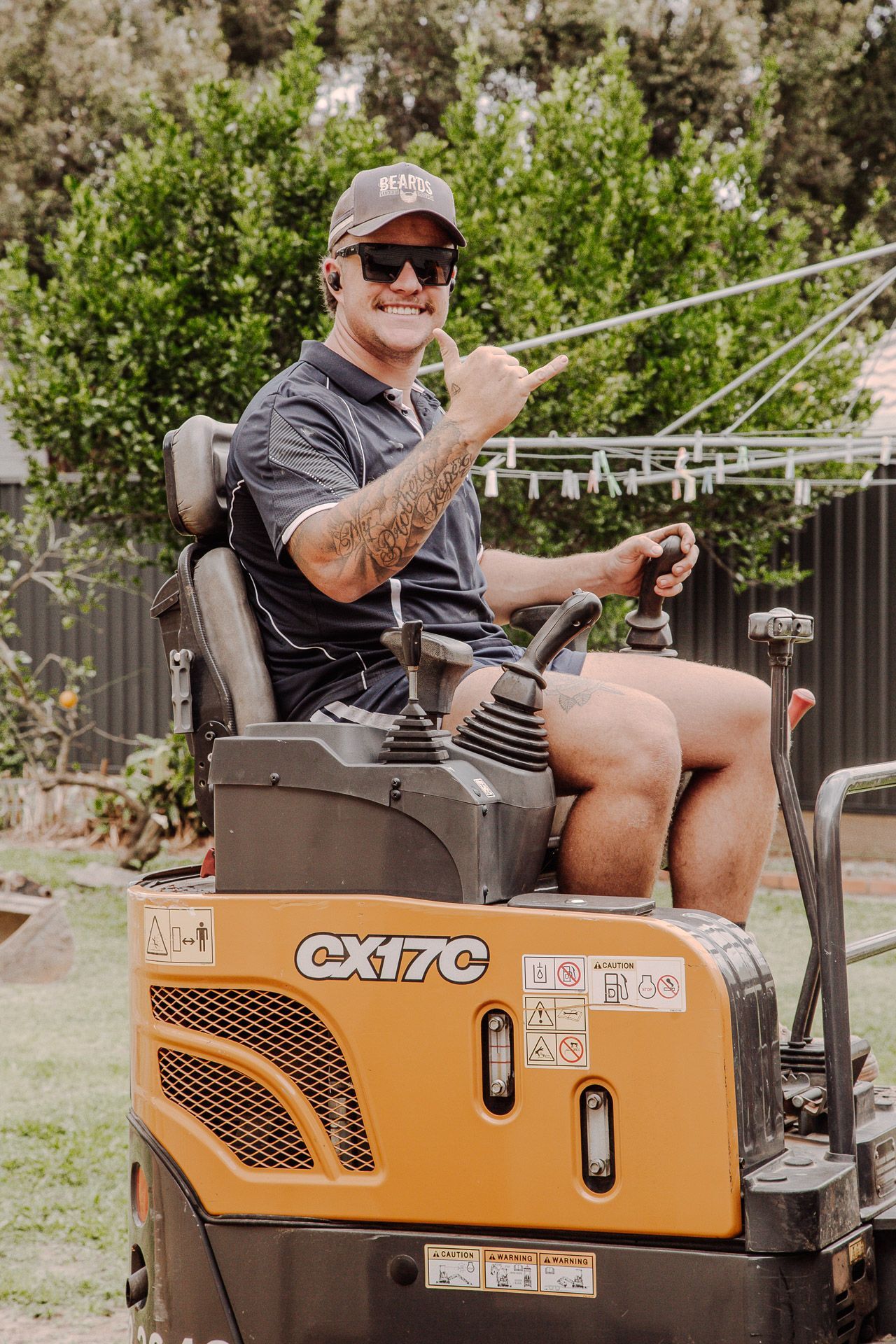 Man is Sitting on a Tractor and Giving a Thumbs Up — Beards Roofing and Plumbing in Clontarf, QLD