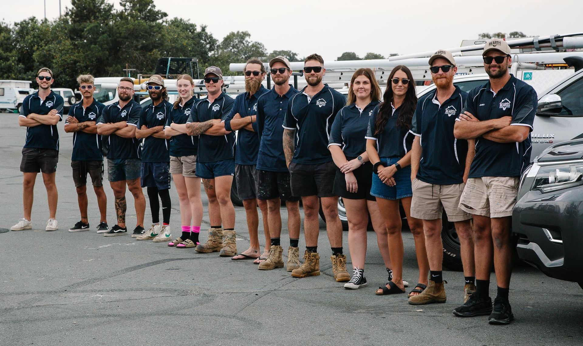 A Man is Standing in Front of a Truck With the Word Beard on It — Beards Roofing and Plumbing in Clontarf, QLD