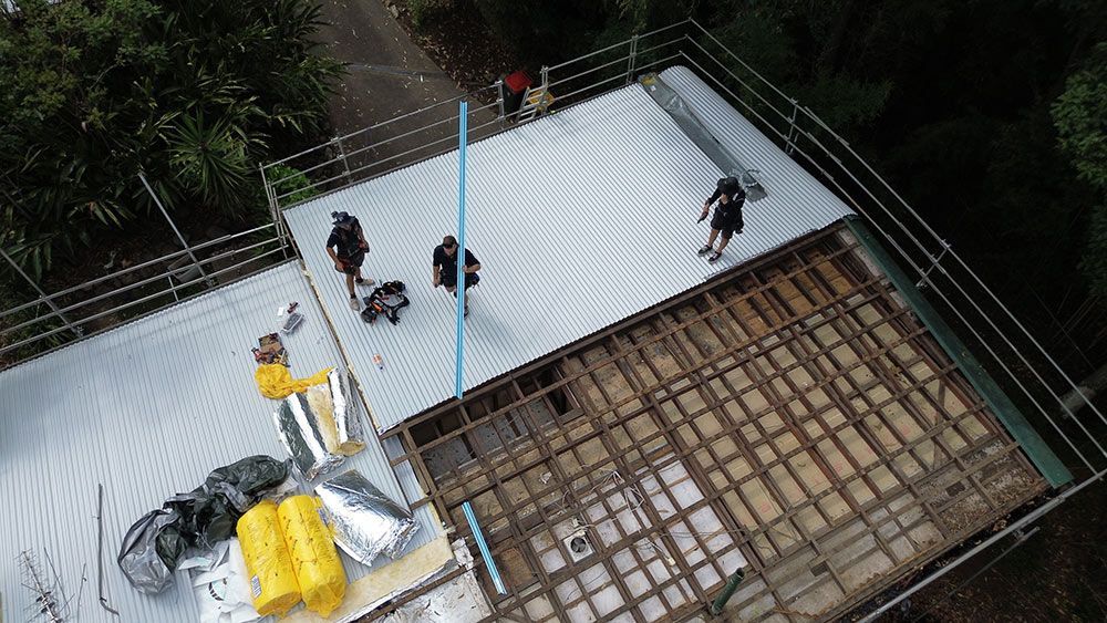 An Aerial View of a Group of People Working on a Roof — Beards Roofing and Plumbing in Caboolture, QLD