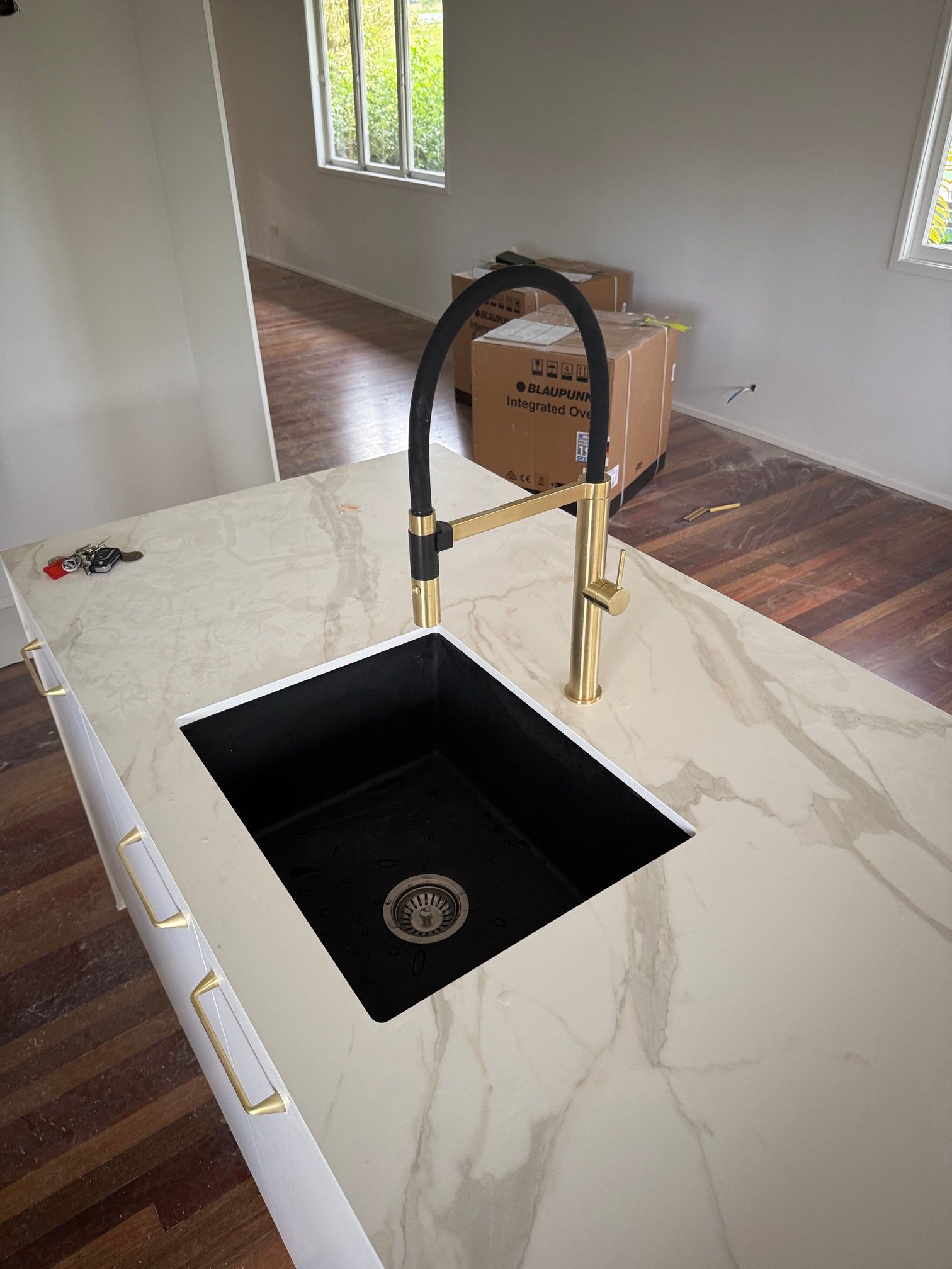 Kitchen With a Black Sink and a Gold Faucet — Beards Roofing and Plumbing in Clontarf, QLD