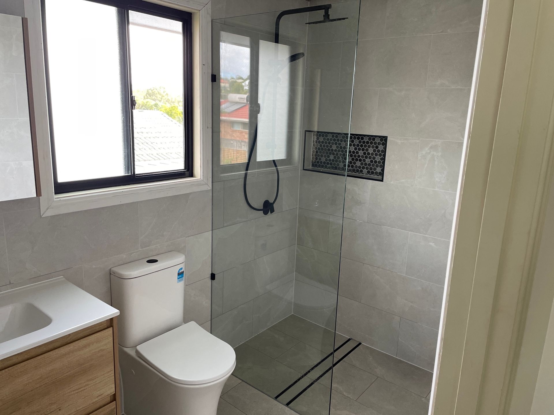 Bathroom With a Toilet, Sink and Walk in Shower — Beards Roofing and Plumbing in Clontarf, QLD
