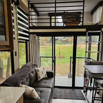 A living room with a couch , table , and sliding glass doors.