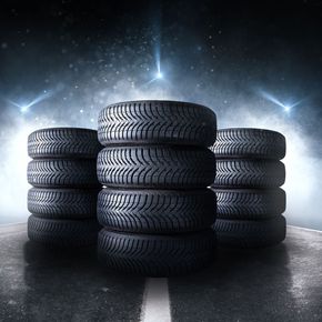 A stack of tires sitting on top of each other on the side of a road.