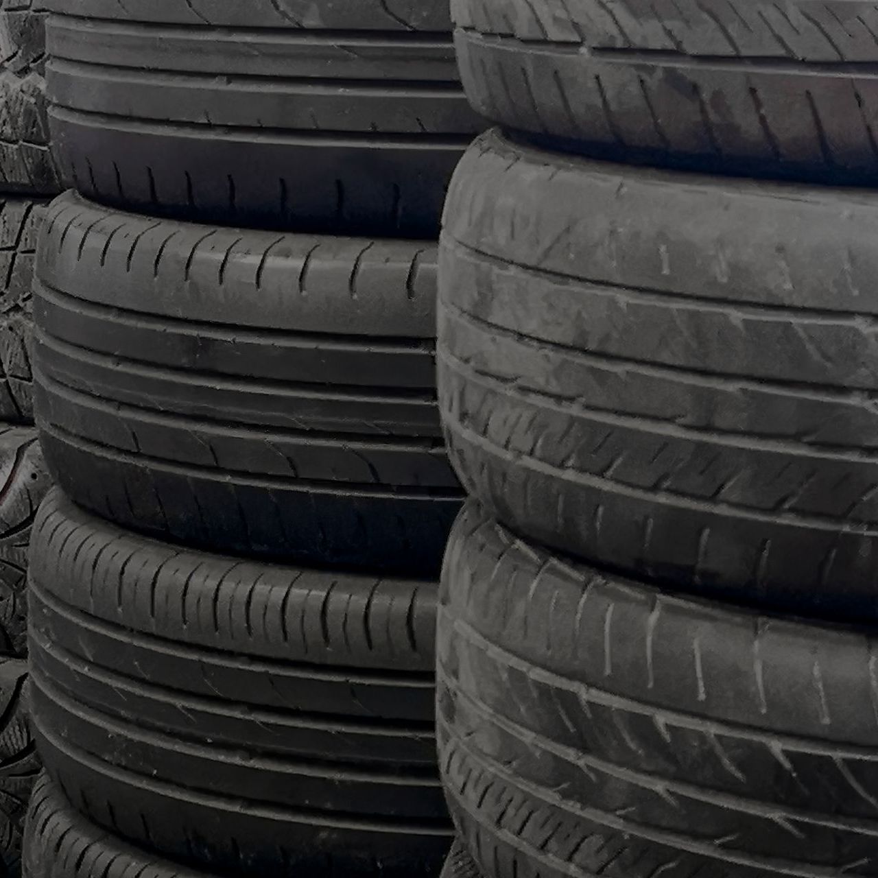 A pile of tires are stacked on top of each other.