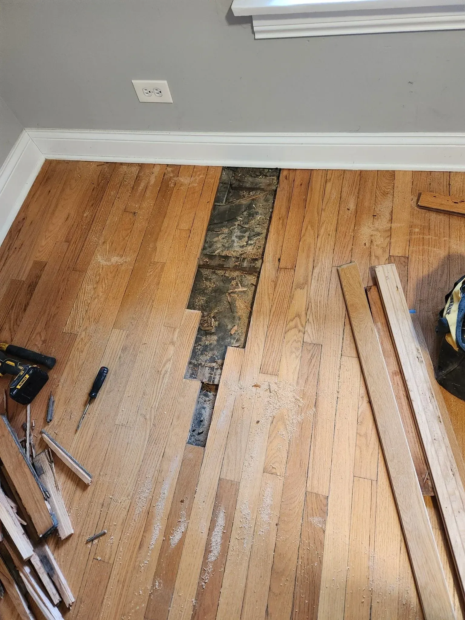 A room with a wooden floor and a lot of tools on it.