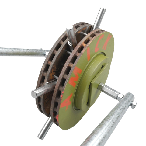 A rusty, vented brake disc painted olive green, mounted on a metal frame with four extending steel rods.