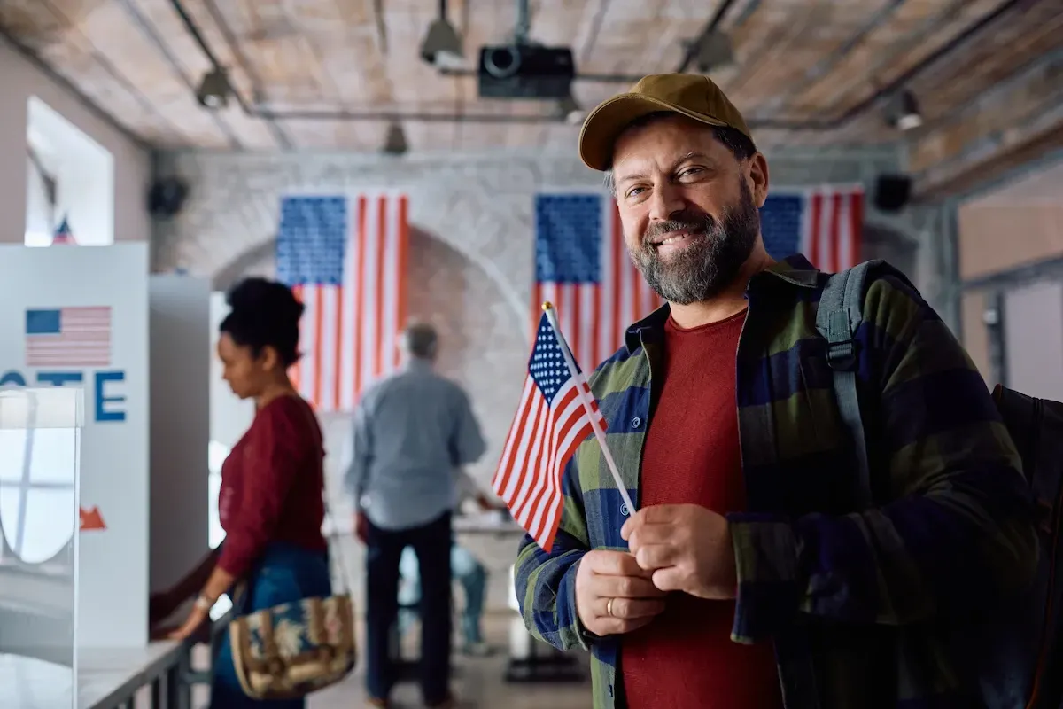 Happy mature man with USA flag in his hands