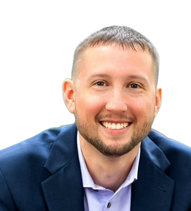 A man with a beard is wearing a blue suit and smiling.