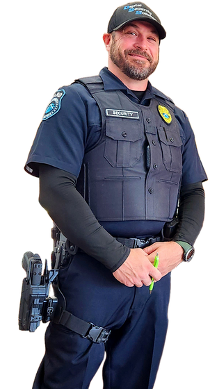 A police officer is standing in front of a white background.