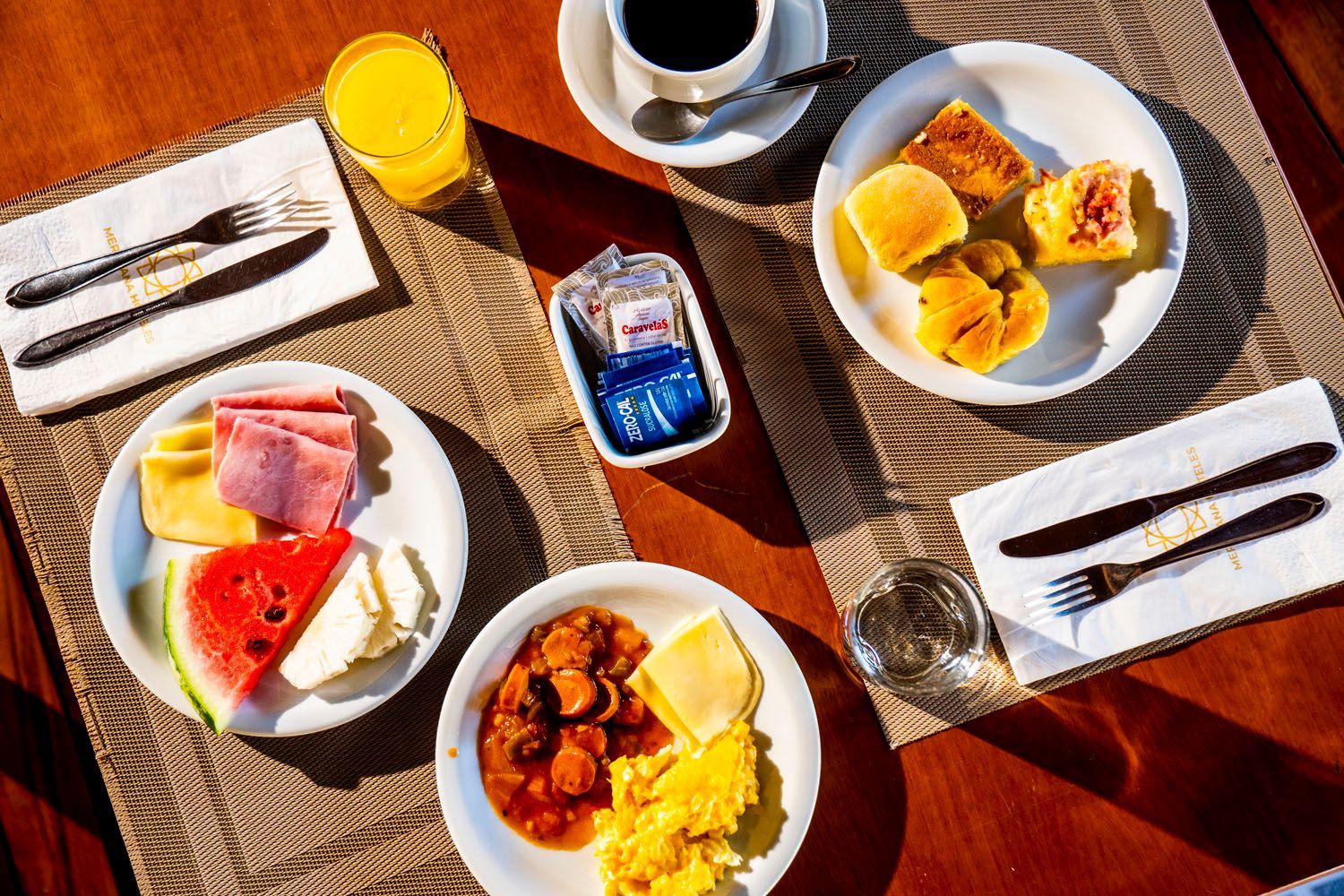 Uma mesa coberta com pratos de comida e uma xícara de café.