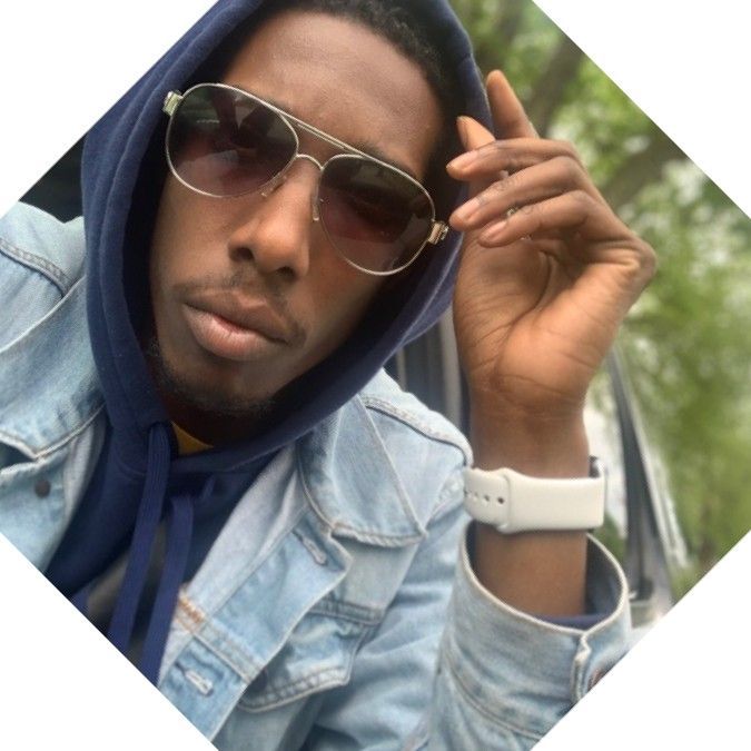 A man wearing sunglasses and a blue hoodie