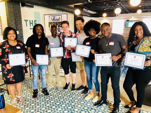 A group of people are standing next to each other holding certificates.