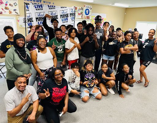 A group of people are posing for a picture in a room.