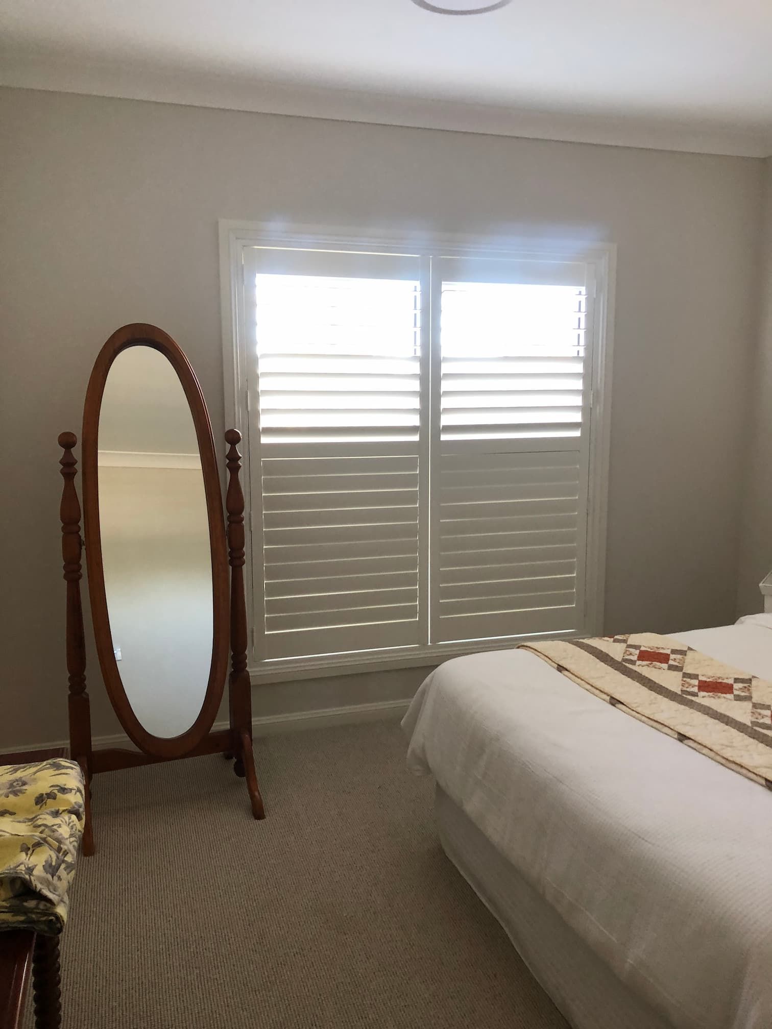 Room With Oval Mirror And Aluminum Shutters  — Window Coverings in Exeter, NSW