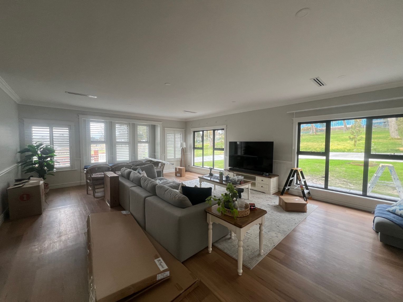 A living room with a couch , table , and television.