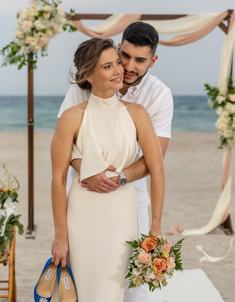 Red balloons and heart decorations in a hotel room, arranged for a romantic celebration on the bed.