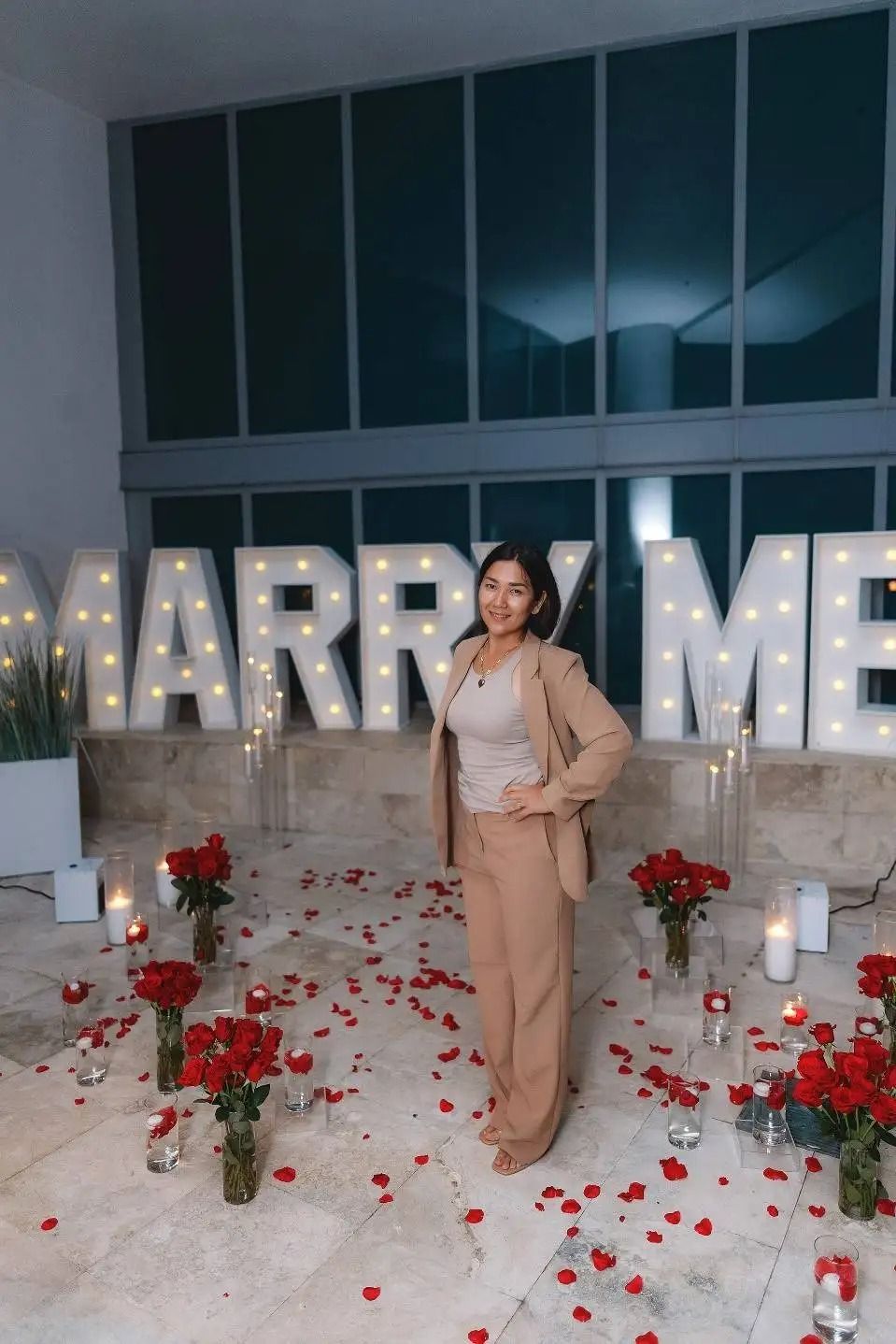 Woman in tan suit poses by