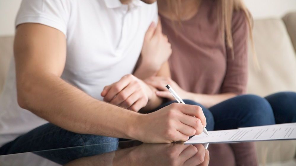 Couple signing first mortgage application