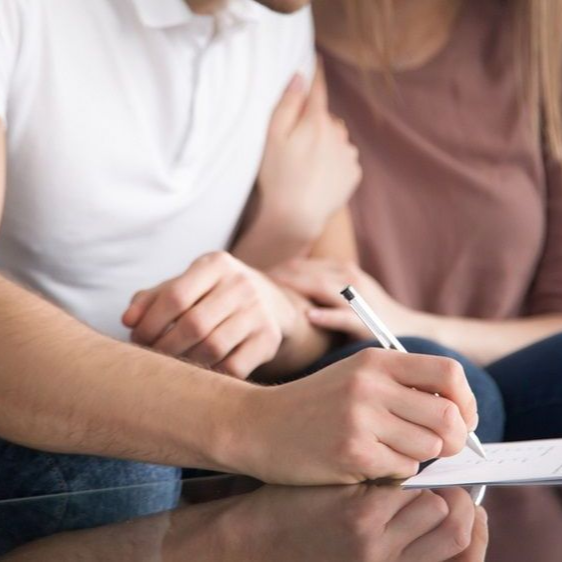 Couple signing first mortgage application