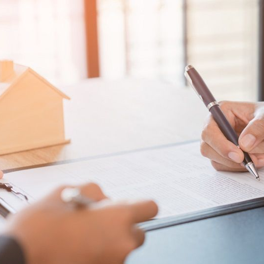 Couple signing first mortgage application