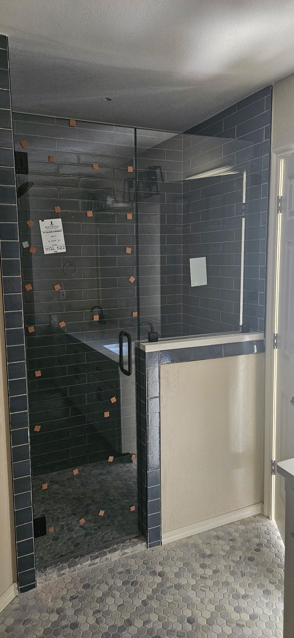 Narrow dark hallway with a partially open door and a beige panel on the right.
