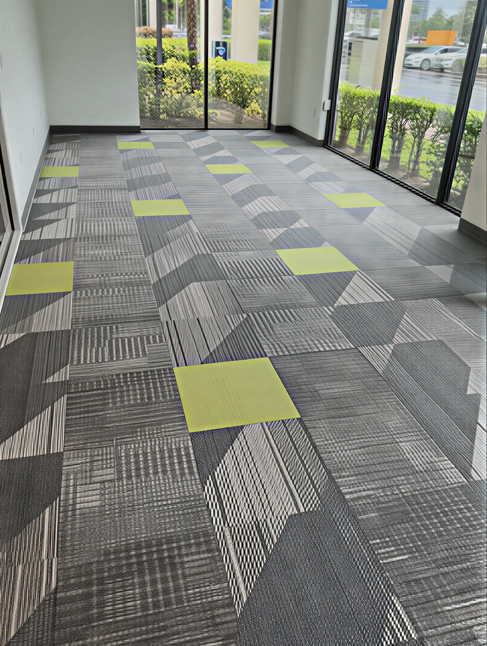 Modern home office with dark desk, shelves, and wood floors. A chair, a window with a view and cowhide rug.