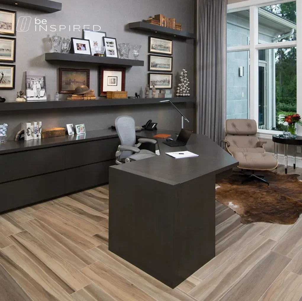 Modern home office with dark desk, shelves, and wood floors. A chair, a window with a view and cowhide rug.