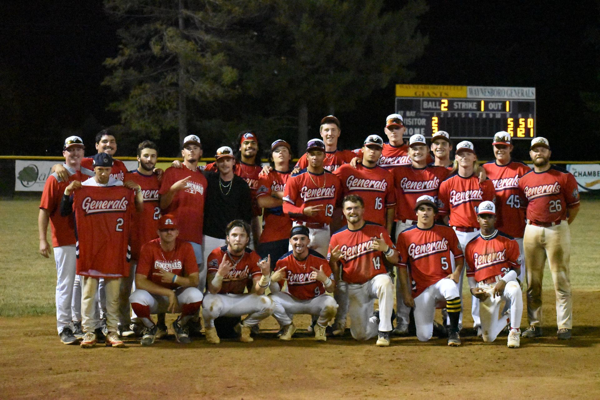 The Waynesboro Generals posing for a picture with a scoreboard in the background