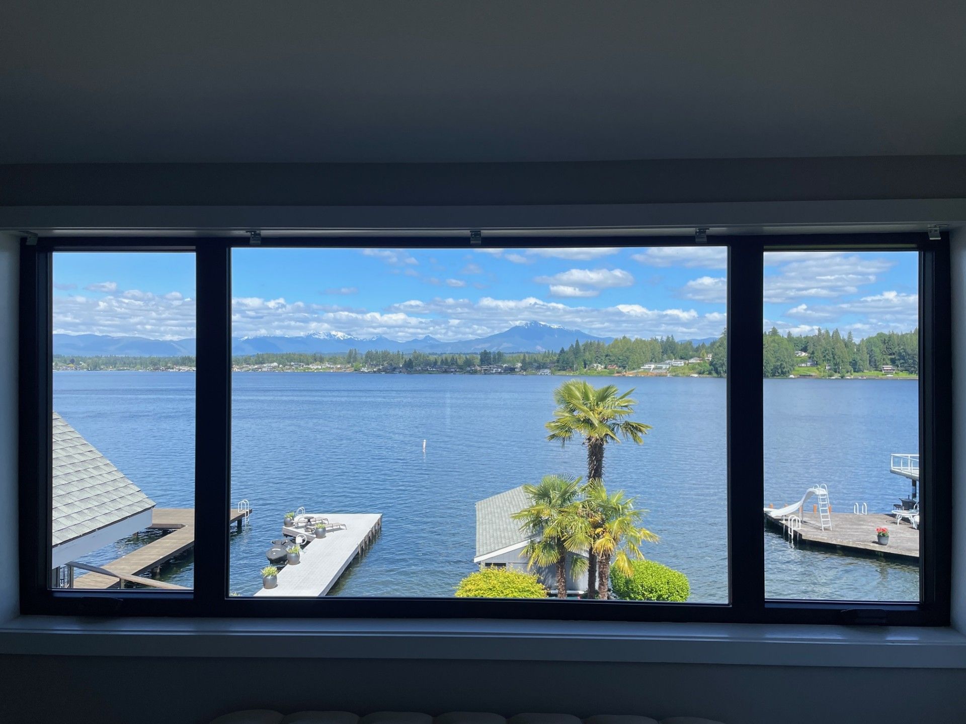 A large window with a view of a lake.