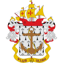 Escudo de armas: barco sobre ancla, florituras blancas y rojas, estandarte "Plus Ultra".