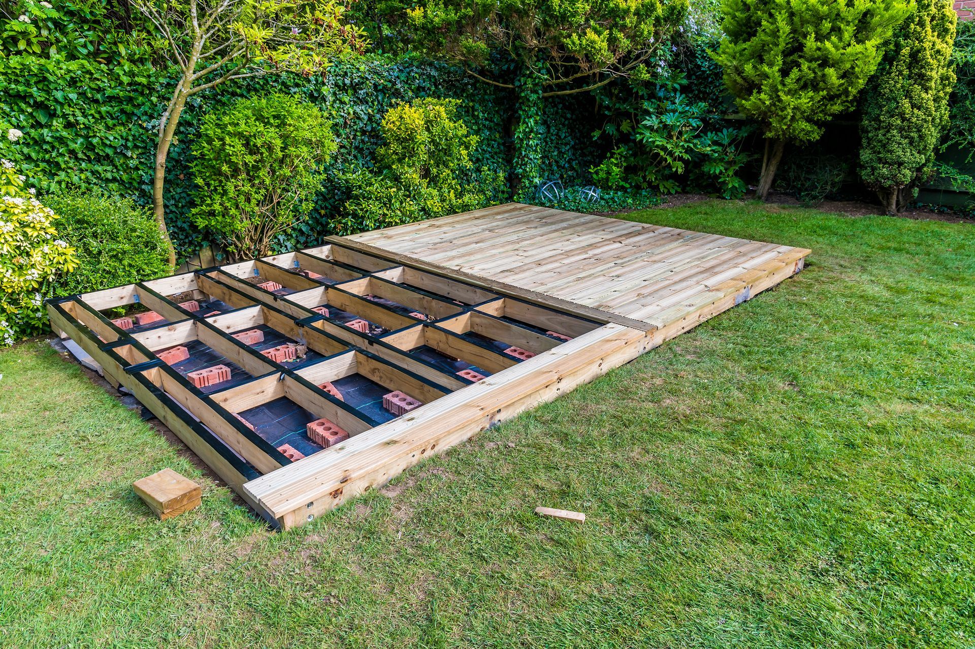 An electric car is being charged at a charging station on a brick wall.