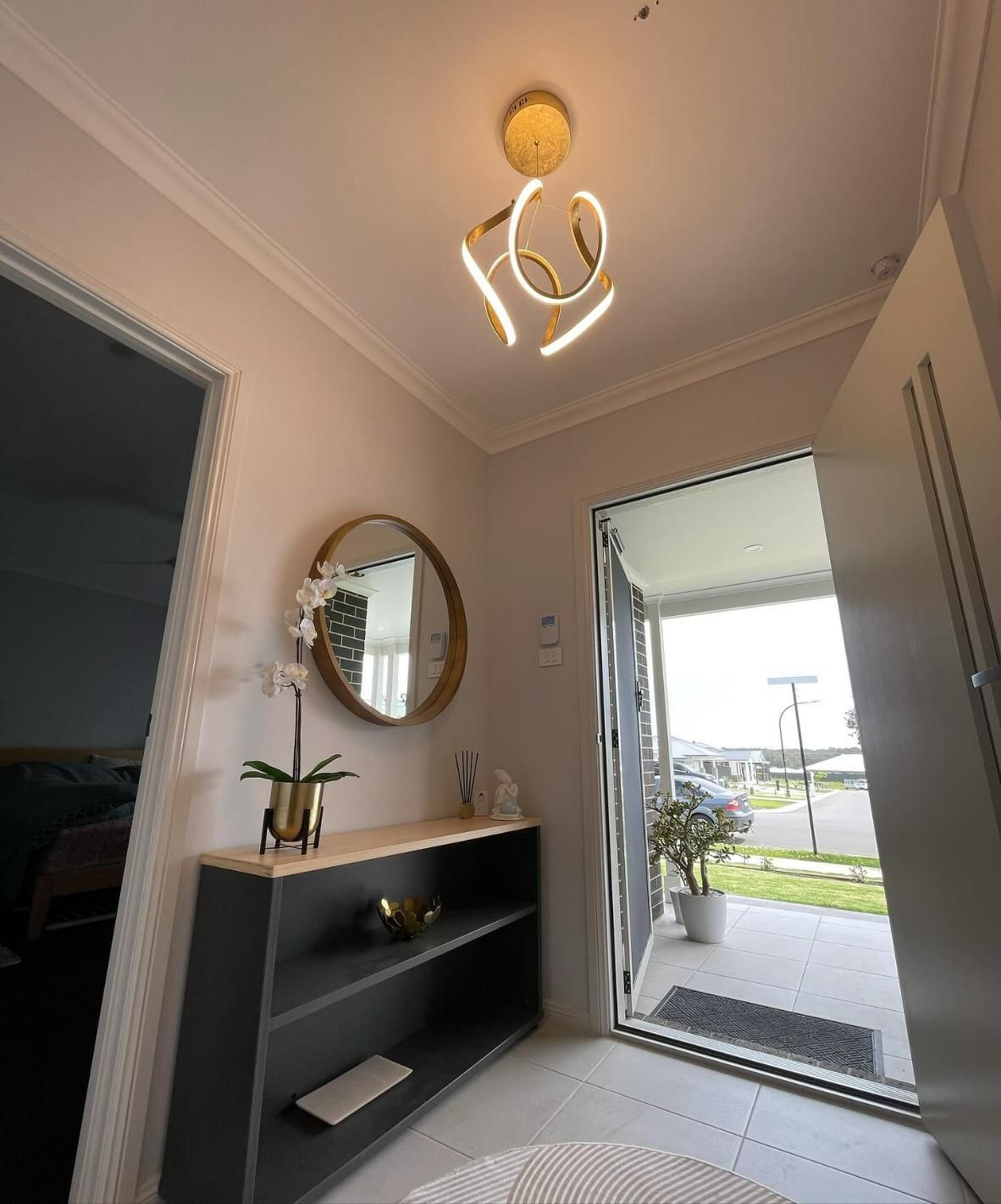 A Hallway with A Mirror and A Light Hanging from The Ceiling — KARM Electrical Services In East Maitland, NSW