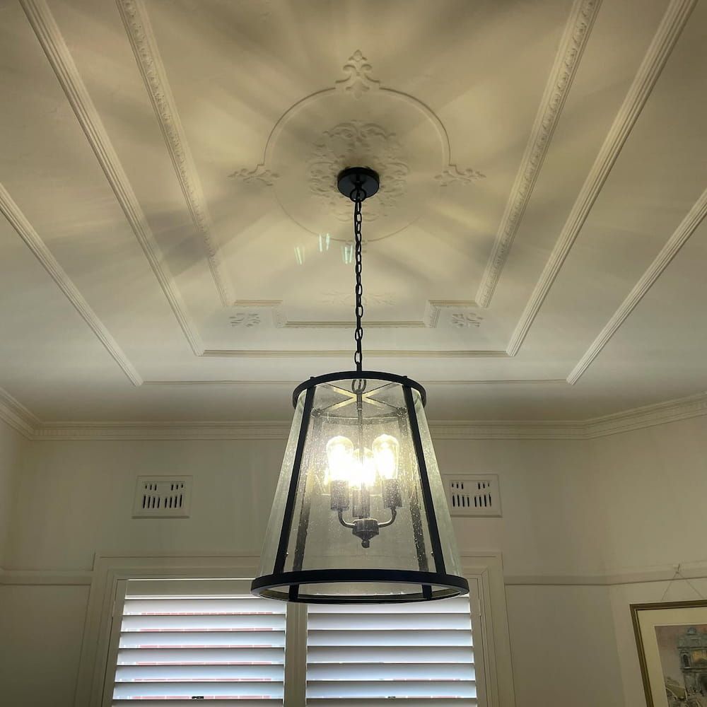 A light fixture is hanging from the ceiling in a room — KARM Electrical Services In Medowie, NSW