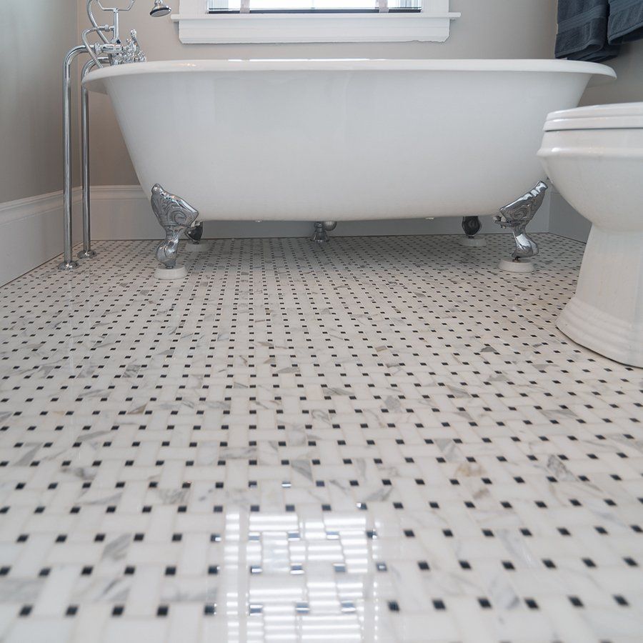 A bathroom with a claw foot tub and a toilet