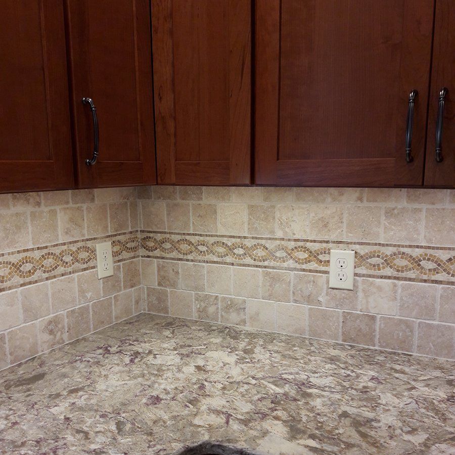 A kitchen with wooden cabinets and granite counter tops.