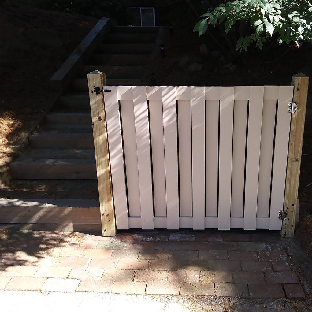 A white fence with stairs in the background