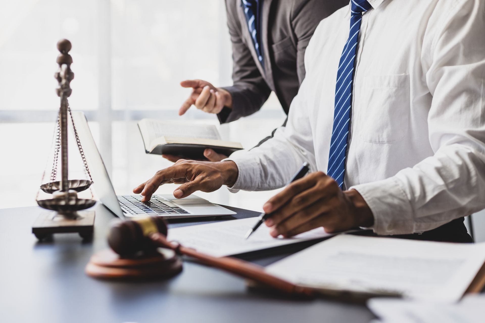 Two attorney reviewing documents at a desk