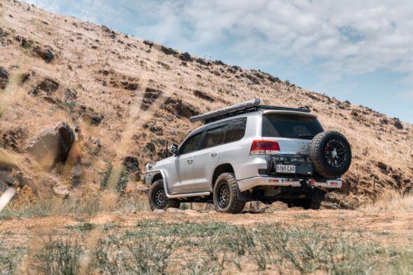 A White Suv Is Parked On Top Of A Dirt Hill — BOEX Tyres And Performance in Bowral, NSW