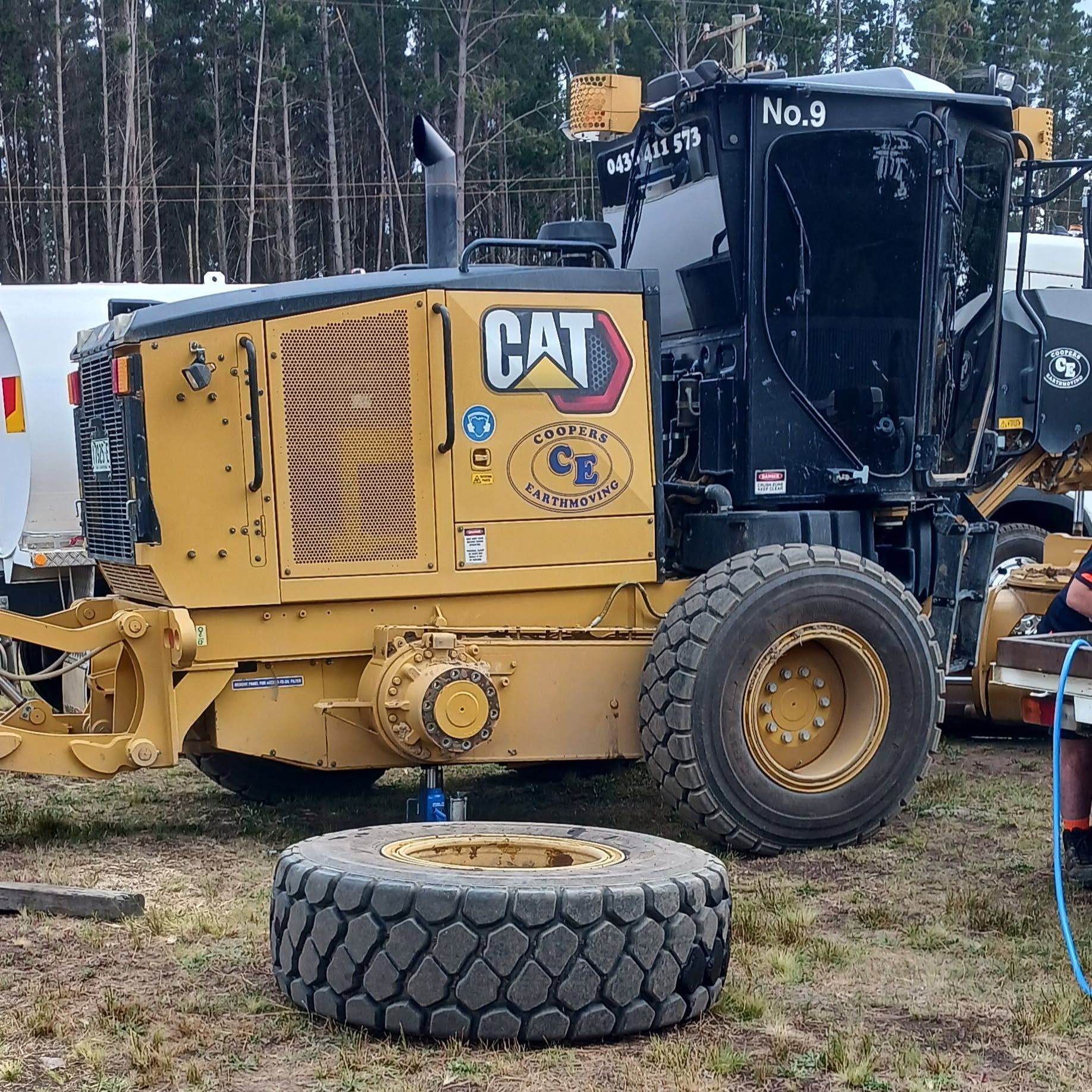 Yellow Cat Road Roller With a Detached Tyre in Front  — BOEX Tyres And Performance in Bowral, NSW