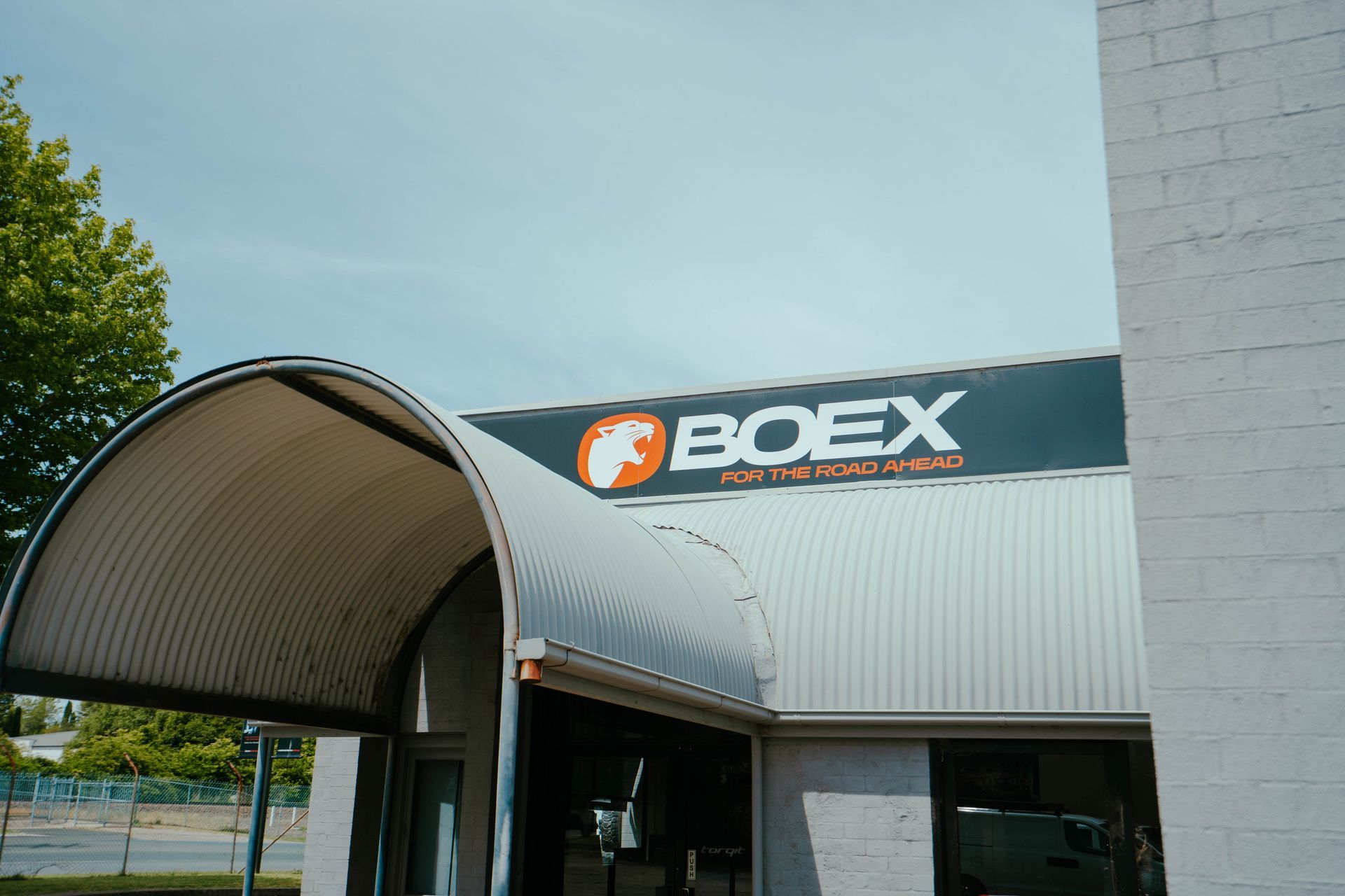 Red Car With New Black Off Road Tyres — BOEX Tyres And Performance in Bowral, NSW