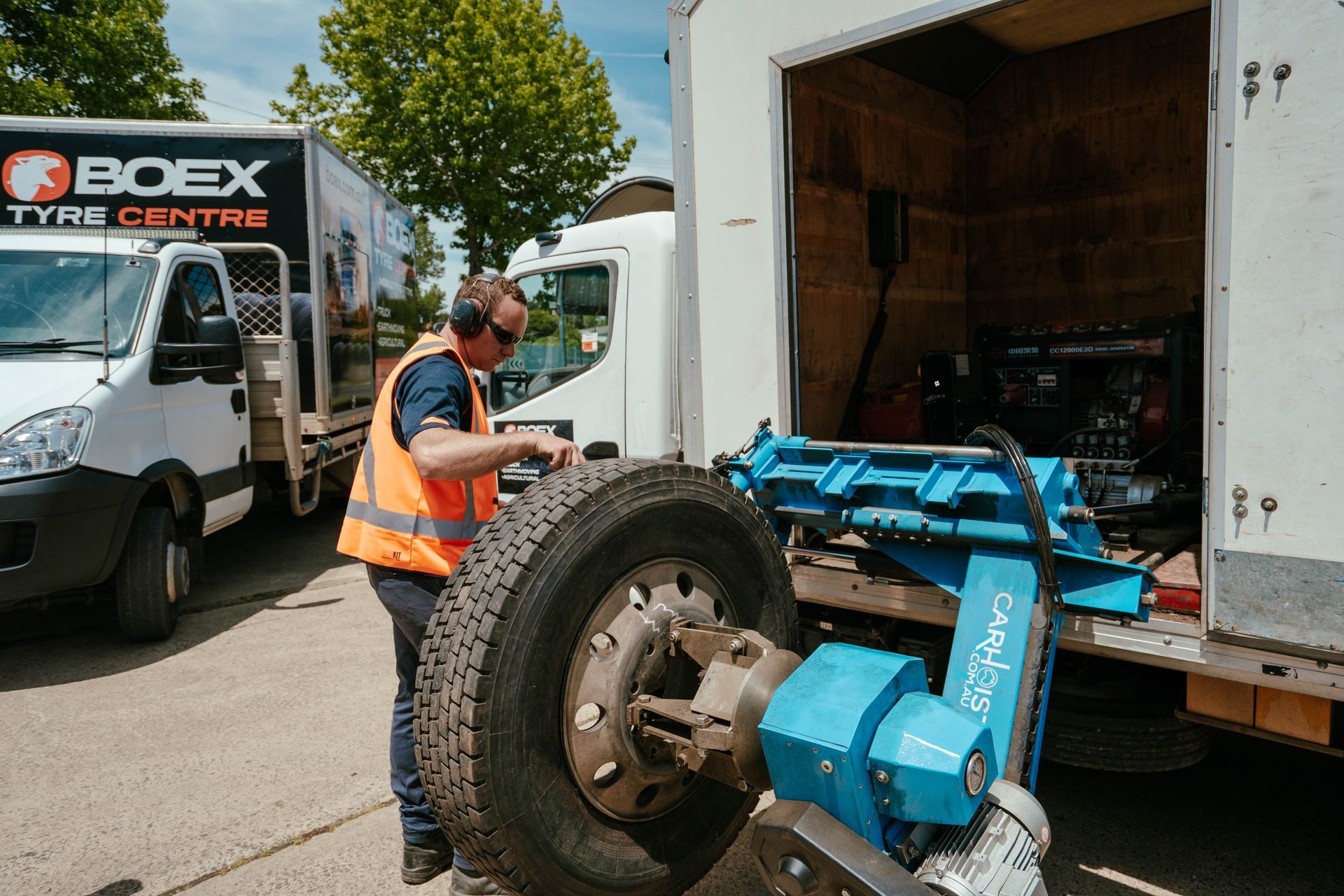 A Man Change A Truck Tyre in a Garage — BOEX Tyres And Performance in Bowral, NSW