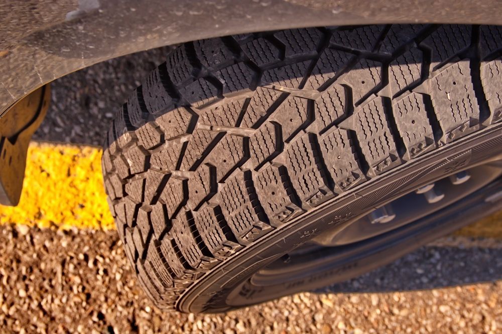 A Close Up Of A Car Tire On A Gravel Road — BOEX Tyres And Performance in Bowral, NSW