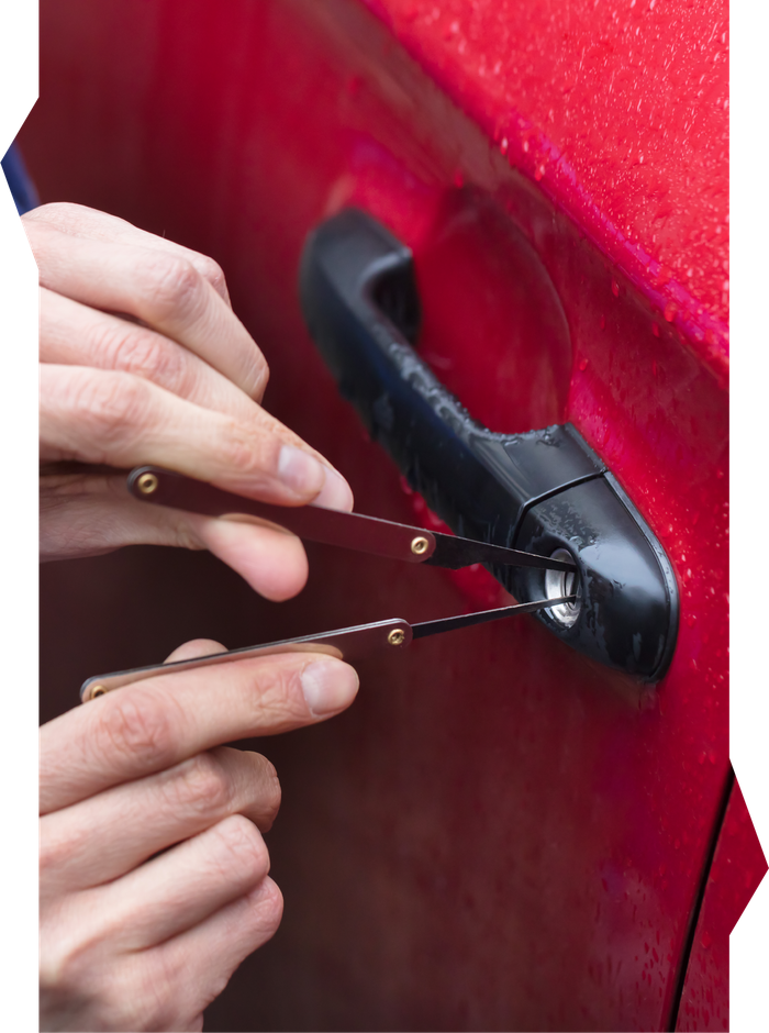 A person is opening a car door with a pair of scissors.