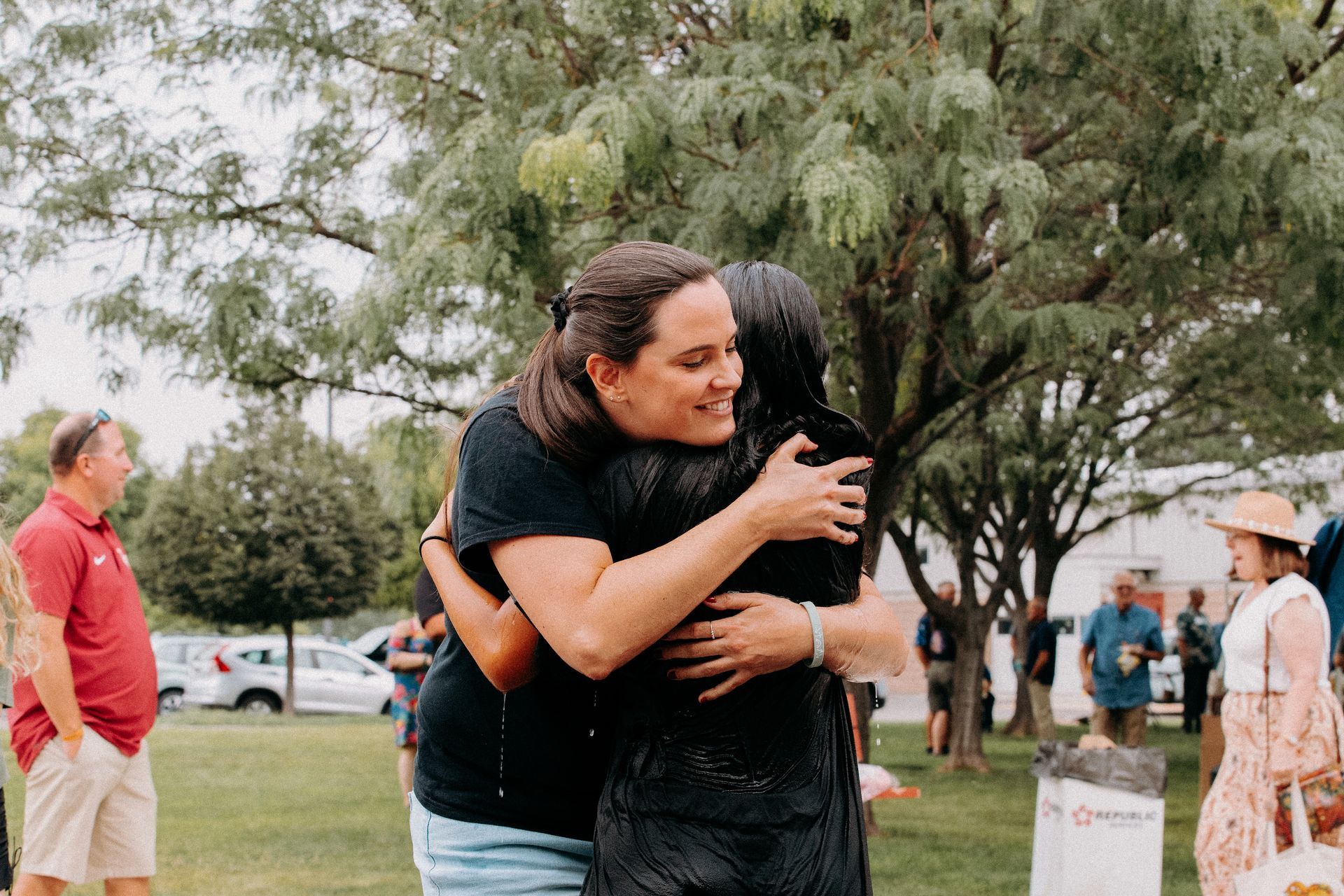 A group of people are walking down the street in the snow.